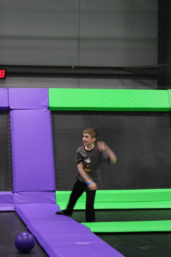 Boy Throwing Dodgeball on Trampoline